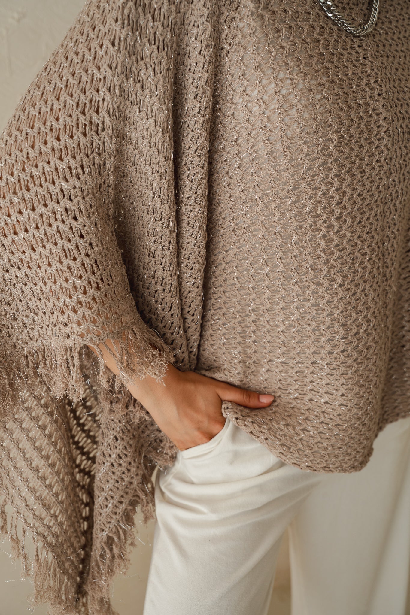 The crochet cape in Shimmer Taupe