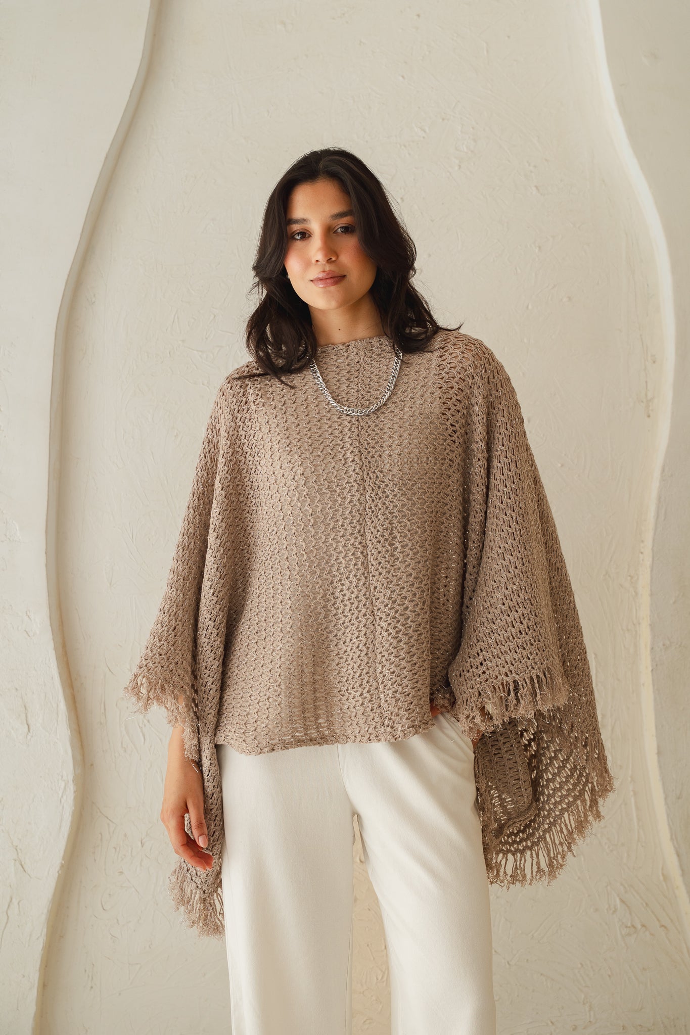The crochet cape in Shimmer Taupe