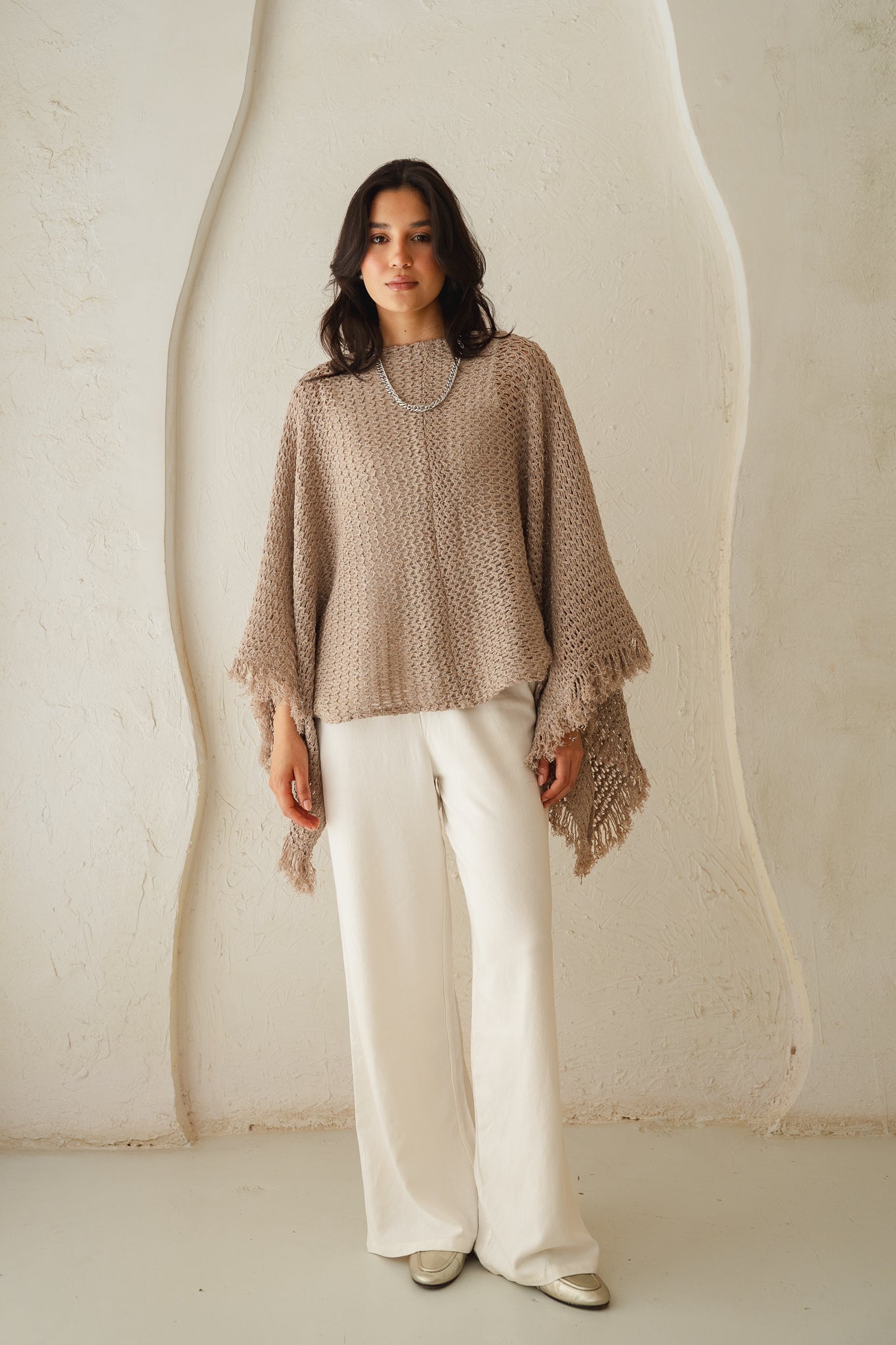 The crochet cape in Shimmer Taupe