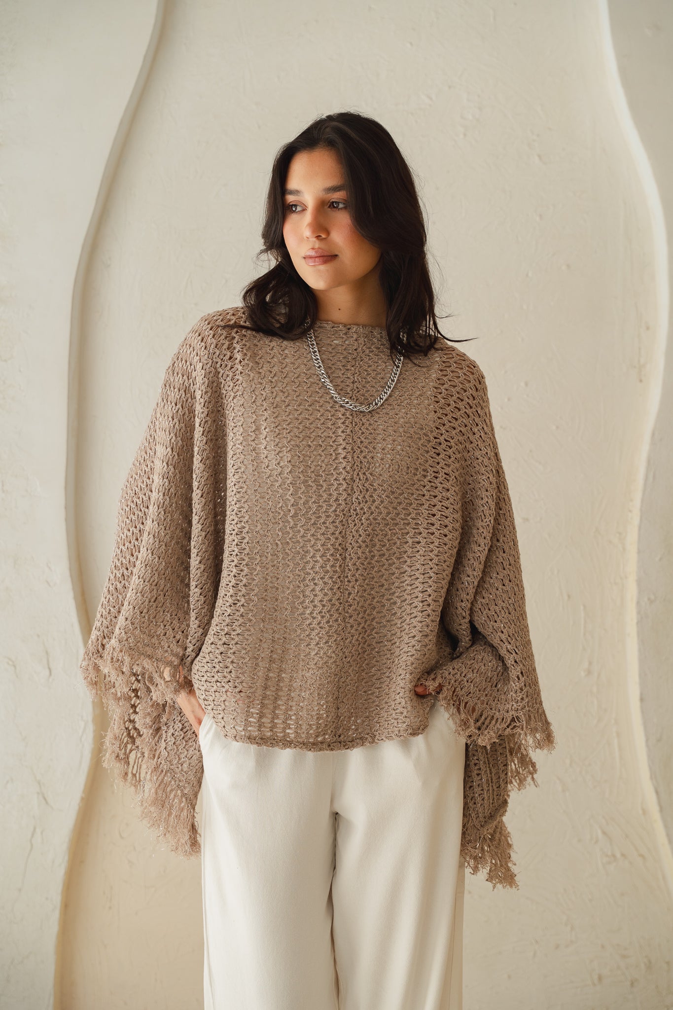 The crochet cape in Shimmer Taupe