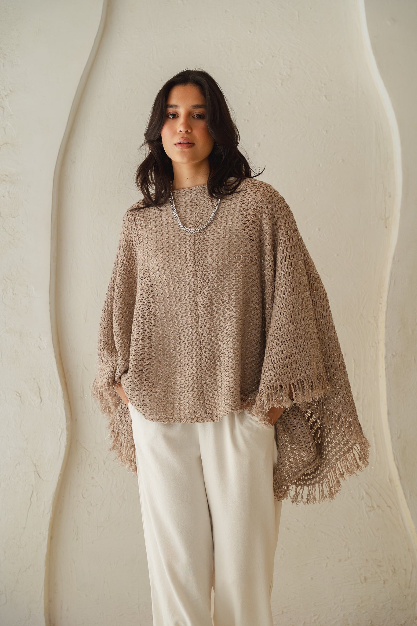 The crochet cape in Shimmer Taupe