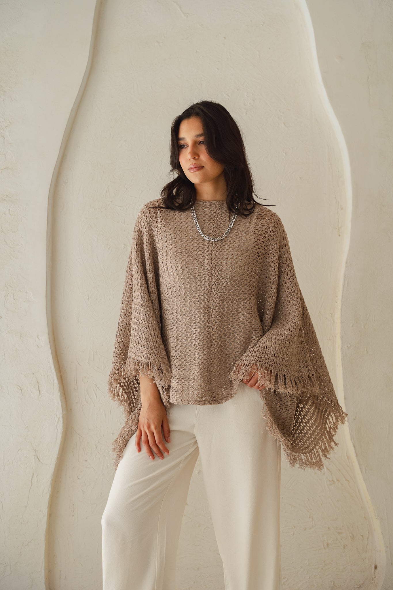 The crochet cape in Shimmer Taupe