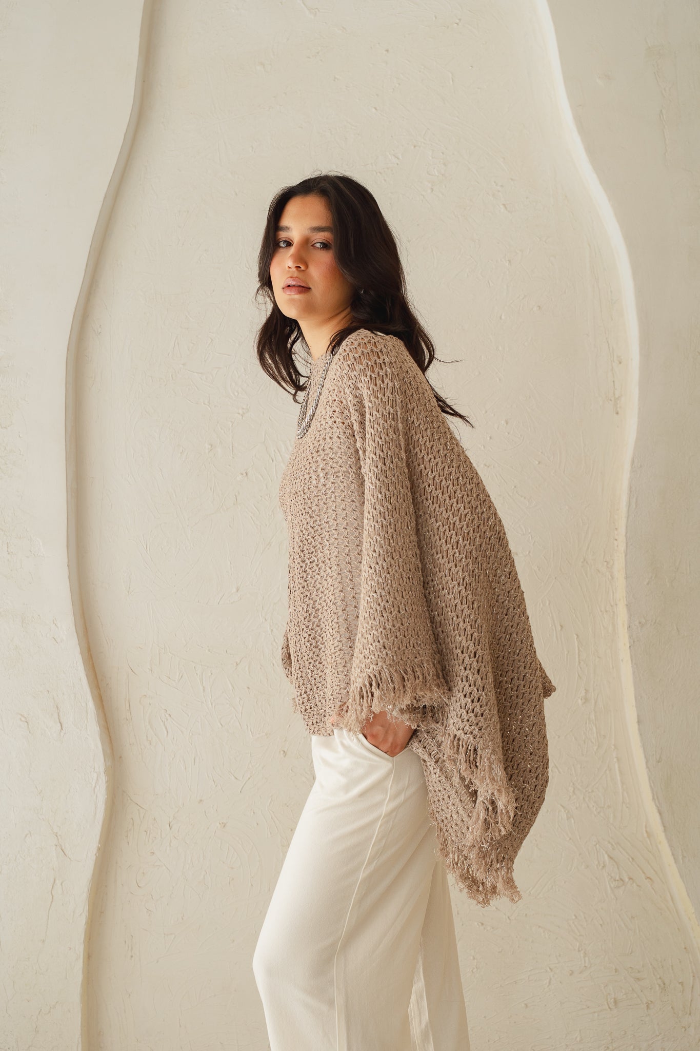 The crochet cape in Shimmer Taupe