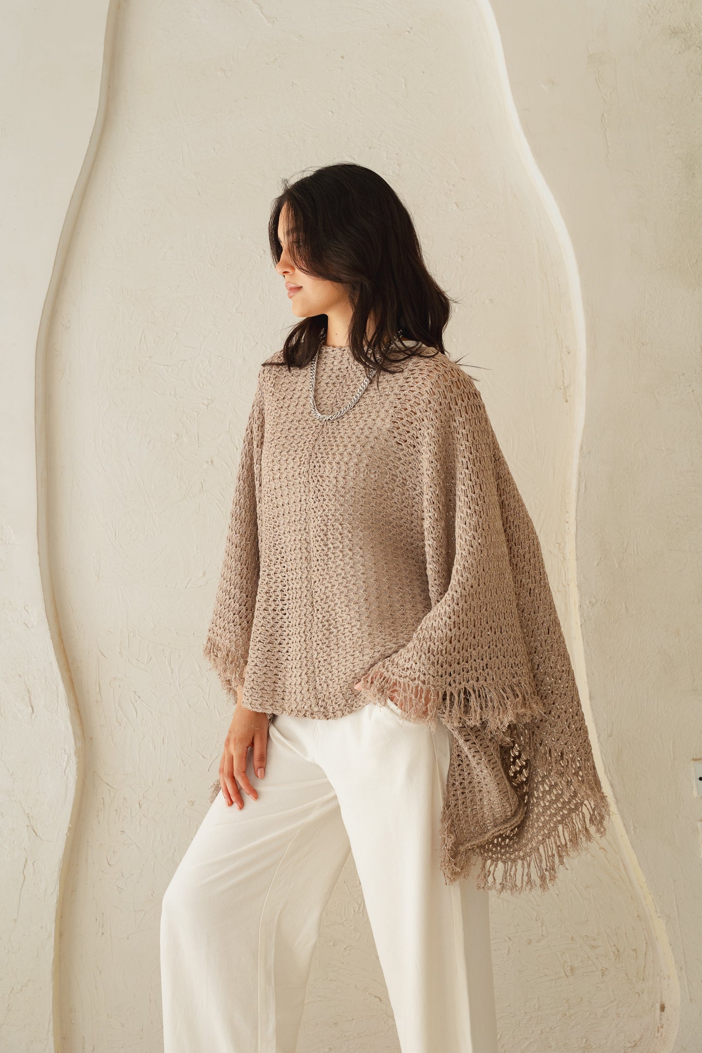 The crochet cape in Shimmer Taupe