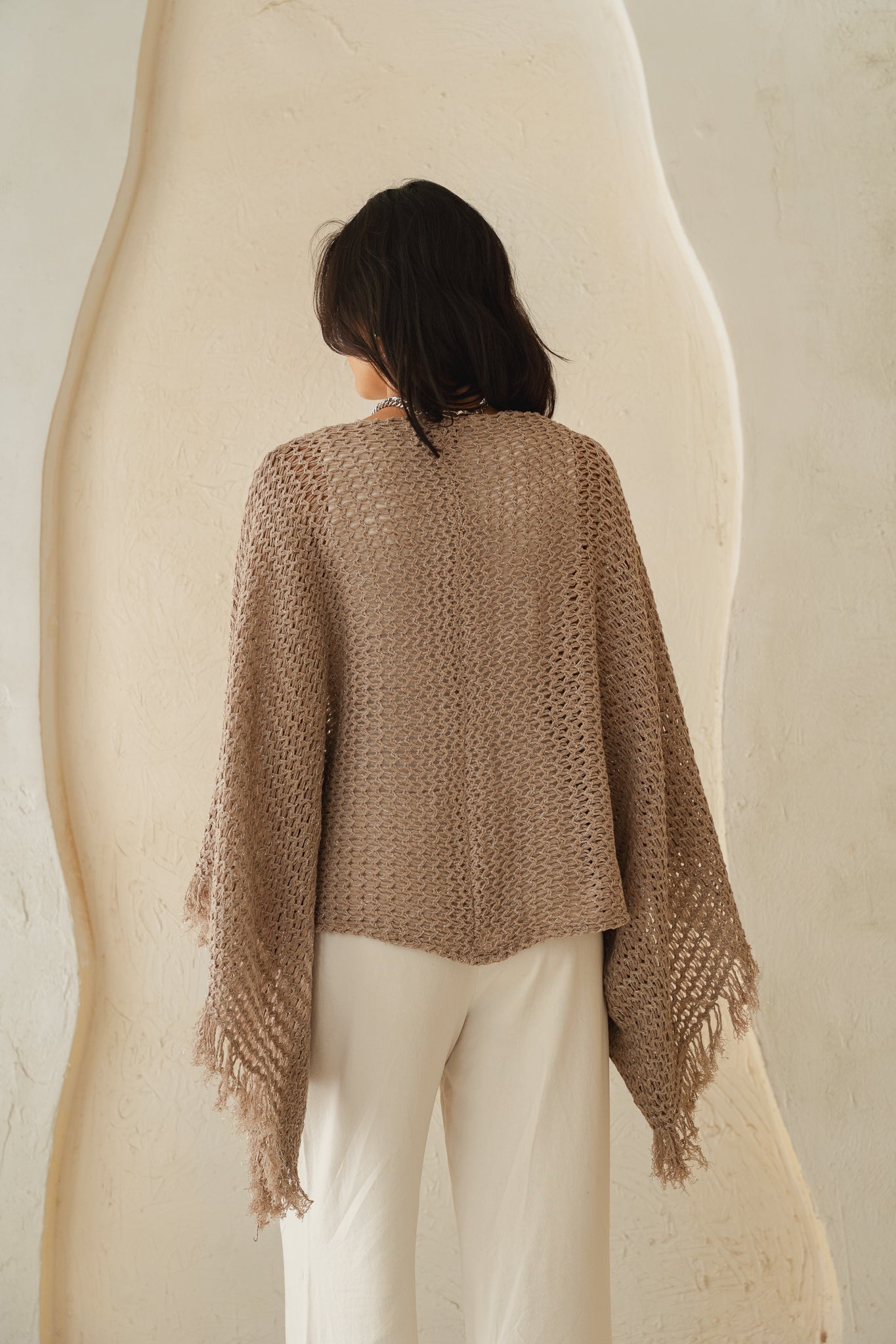 The crochet cape in Shimmer Taupe