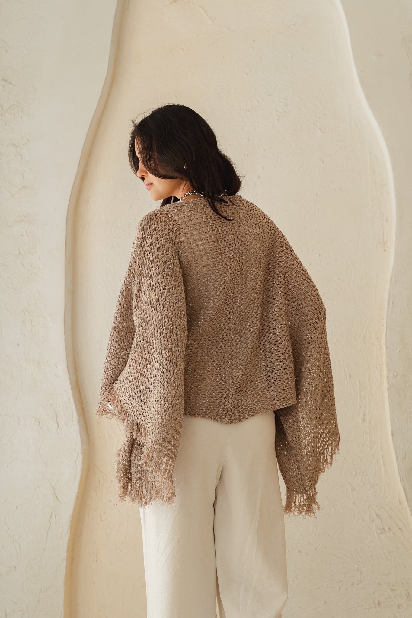 The crochet cape in Shimmer Taupe