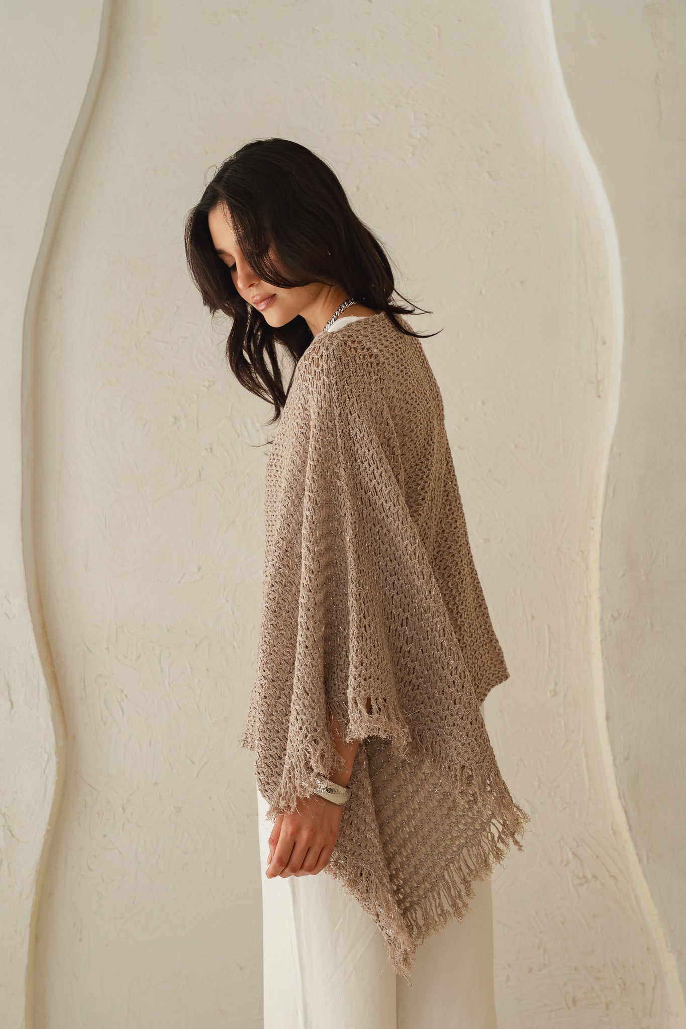 The crochet cape in Shimmer Taupe