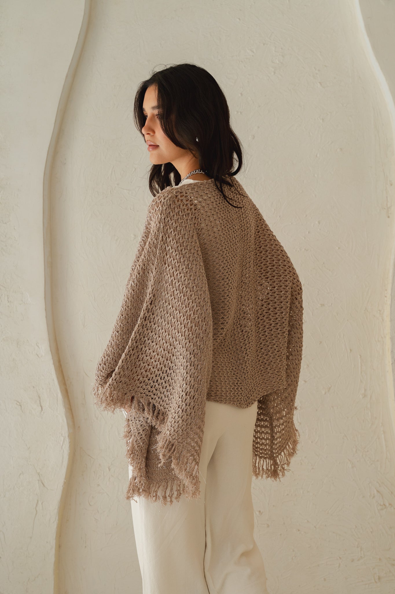 The crochet cape in Shimmer Taupe